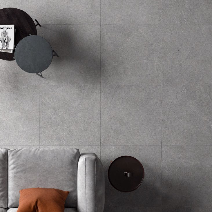 Lithos Stone Grey matte porcelain tile with a stone design, for floors and walls. Installed in a room.