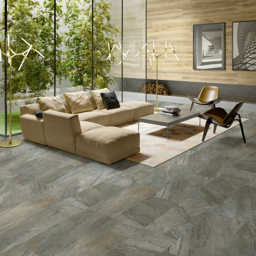 Utah Granite matte porcelain tile with a grey stone design, for floors and walls. Made in Italy, installed in a room.